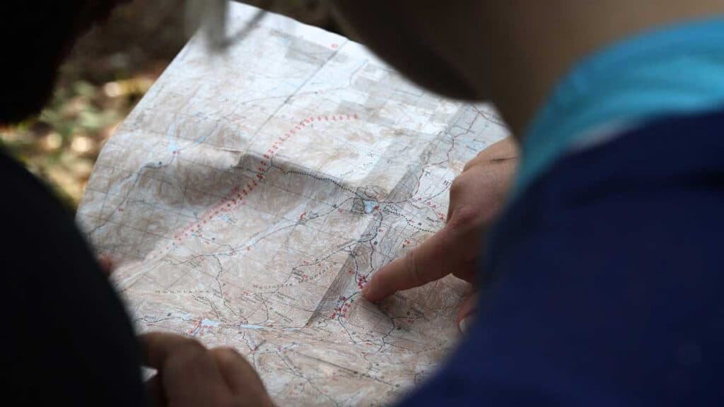 Hiker pointing to a map